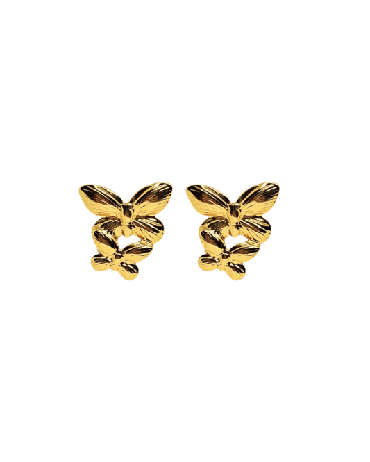 Gold butterfly earrings on a white background