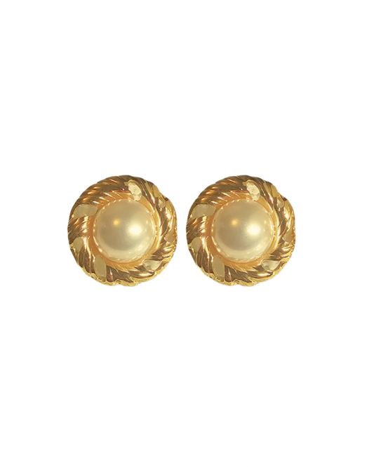 Pair of gold earrings with pearl-like centers on a white background