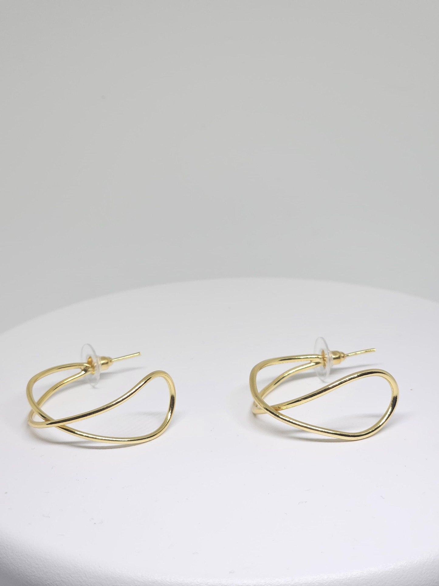 Close-up of Minimalist Gold Wave Hoop Earrings with unique wave shape