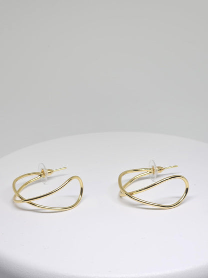 Close-up of Minimalist Gold Wave Hoop Earrings with unique wave shape