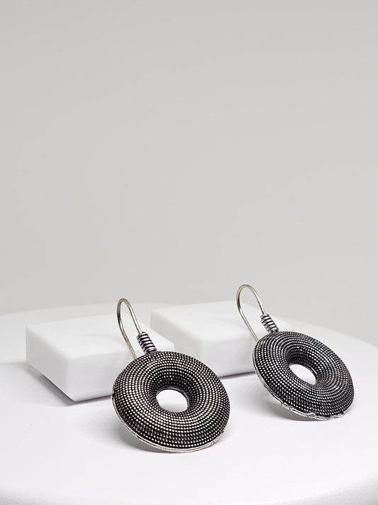 Stylish oxidised silver earrings with unique donut shape and detailed texture, ideal for any occasion.