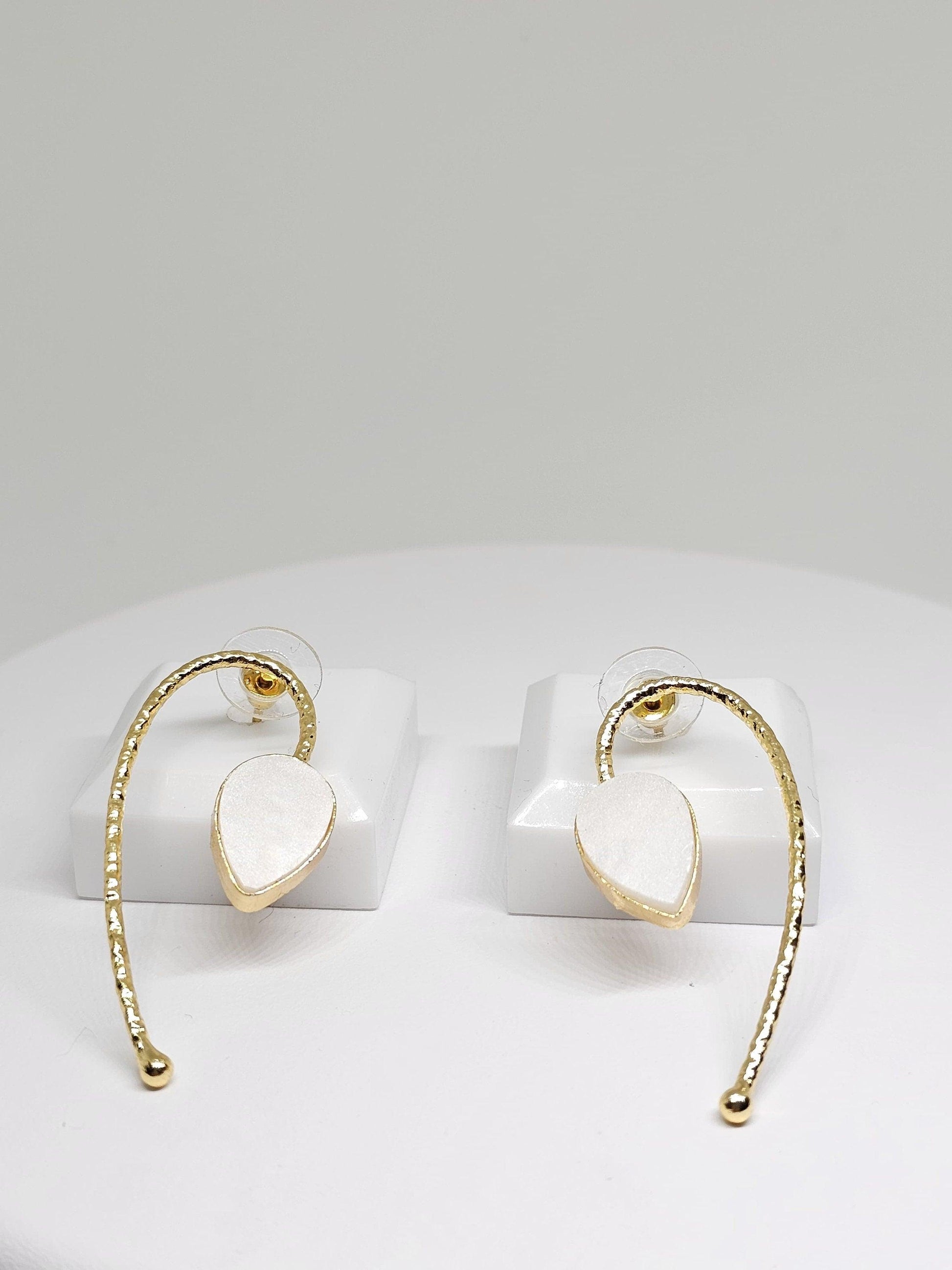 Beautifully designed brass earrings with a polished white stone, featuring a curved dangle style for a modern and sophisticated look