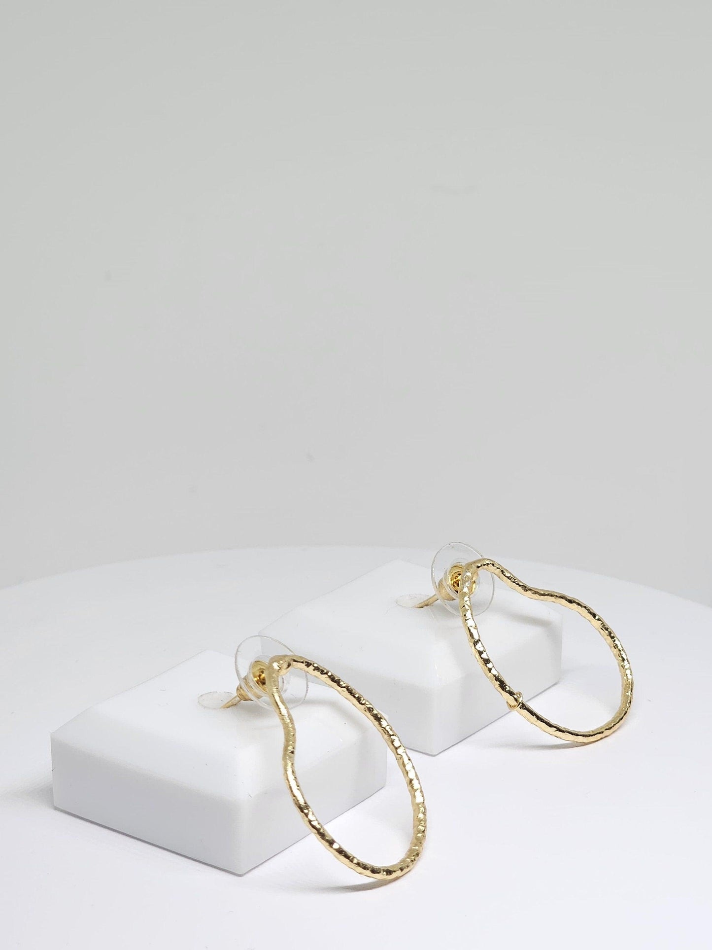 Elegant and versatile, the Simple Brass Pear Hoop Earrings showcase a sleek pear-shaped design in polished brass, offering a timeless addition to your jewelry collection