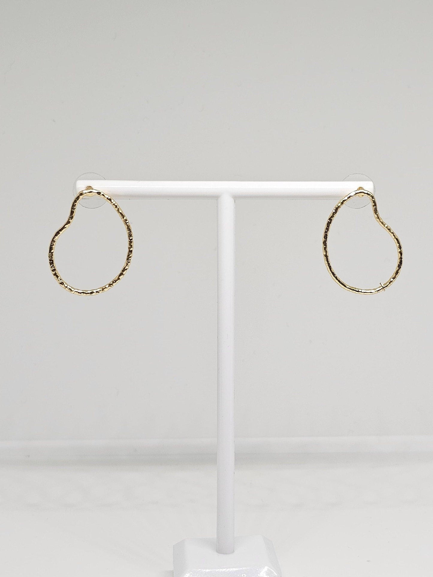 A pair of Simple Brass Pear Hoop Earrings featuring a distinctive pear shape design, crafted from high-quality brass with a luxurious gold-like finish. These elegant earrings are lightweight yet durable