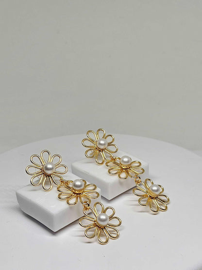 Handcrafted gold flower pearl drop earrings with double floral design, featuring intricate petals and lustrous pearls, perfect for adding elegance and sophistication to any outfit.