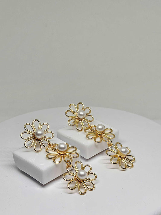 Handcrafted gold flower pearl drop earrings with double floral design, featuring intricate petals and lustrous pearls, perfect for adding elegance and sophistication to any outfit.