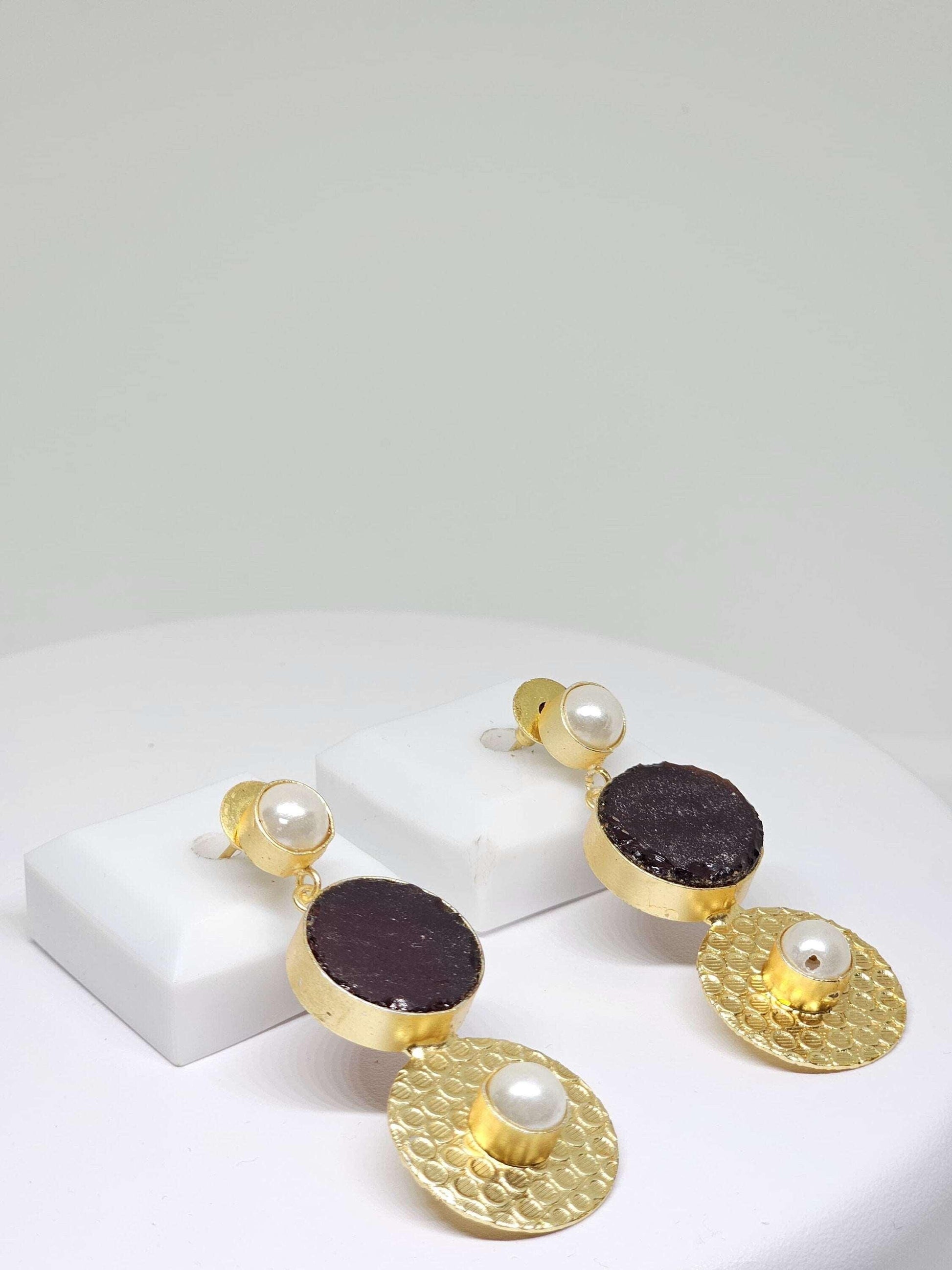 Sophisticated gold drop earrings with a combination of purple stone and pearl accents, perfect for any occasion
