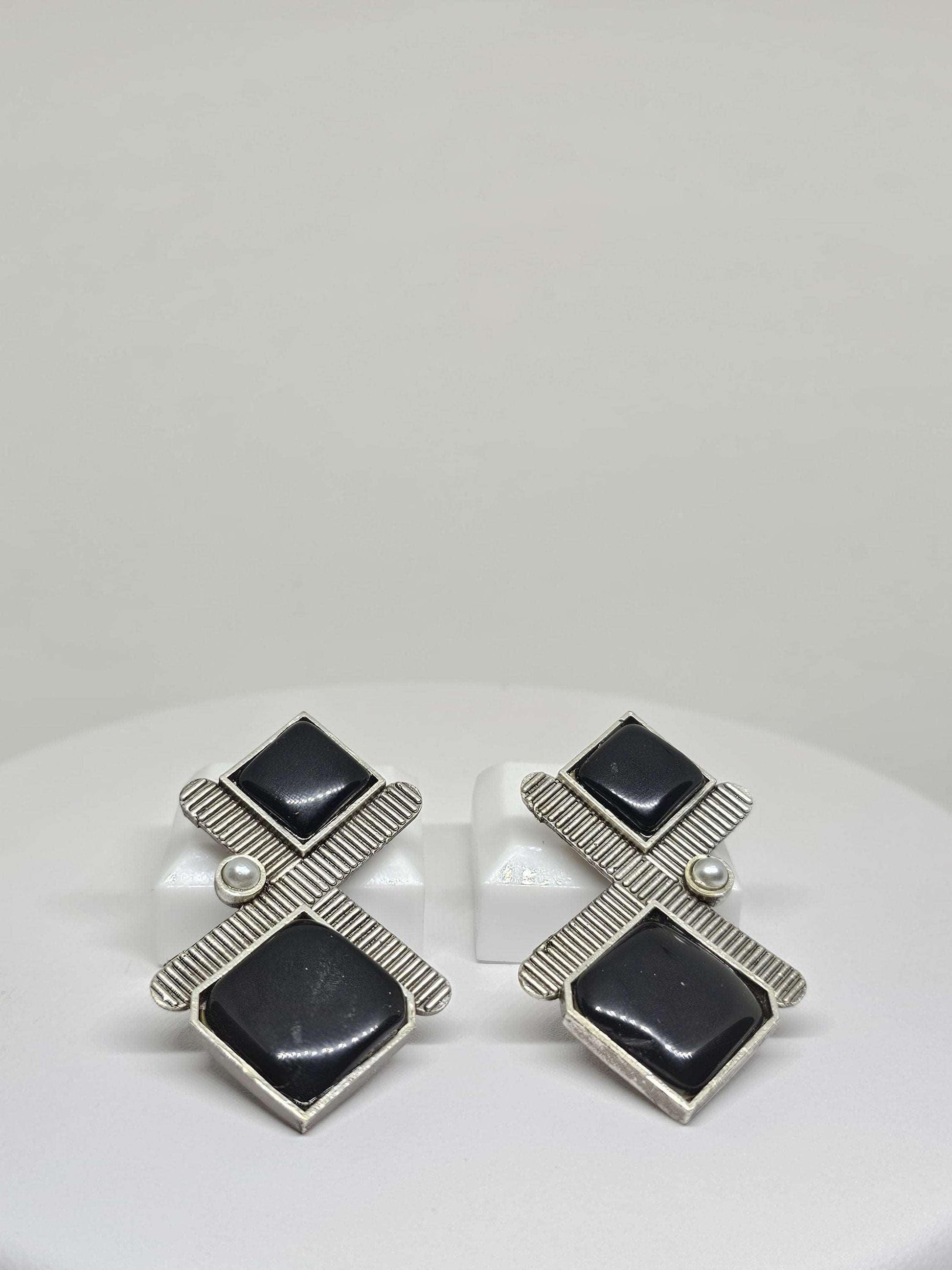 stud earrings with black onyx, handmade from silver-plated brass. The studs feature a contemporary design and are available in classic black and eye-catching red onyx, providing a sophisticated and versatile accessory option for women.