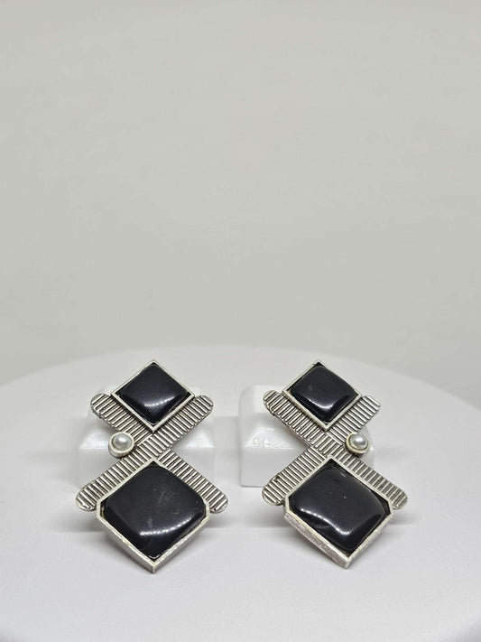 stud earrings with black onyx, handmade from silver-plated brass. The studs feature a contemporary design and are available in classic black and eye-catching red onyx, providing a sophisticated and versatile accessory option for women.