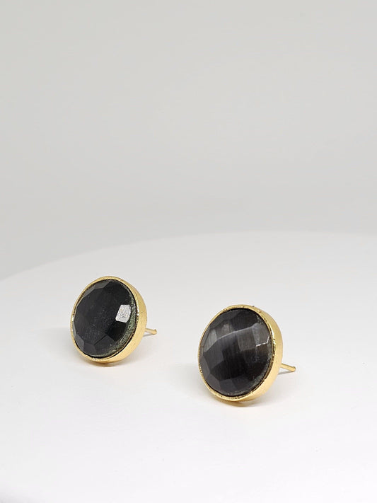 Elegant brass stud earrings with faceted black stones, perfect for adding a touch of sophistication to any outfit.
