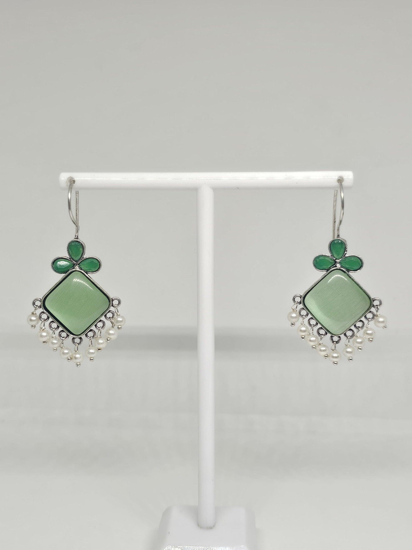 Handcrafted green gemstone earrings with pearl accents.