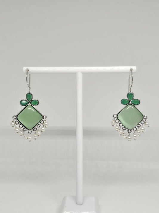 Handcrafted green gemstone earrings with pearl accents.