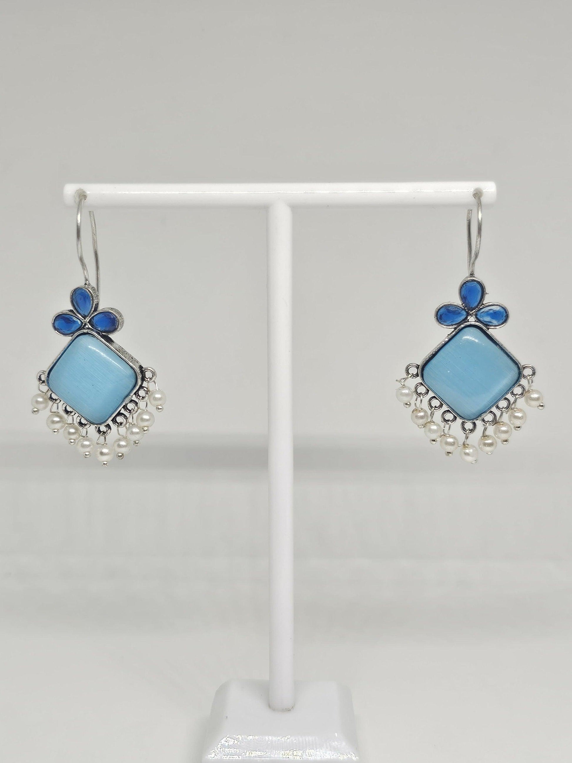 Elegant blue gemstone statement earrings with pearls.