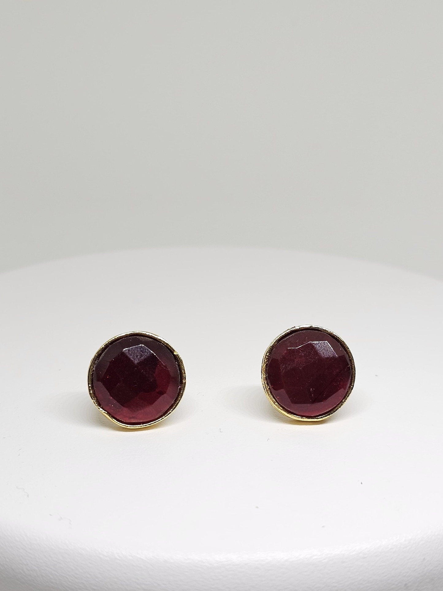 Handcrafted brass stud earrings featuring deep red gemstone, perfect for a sophisticated and elegant look