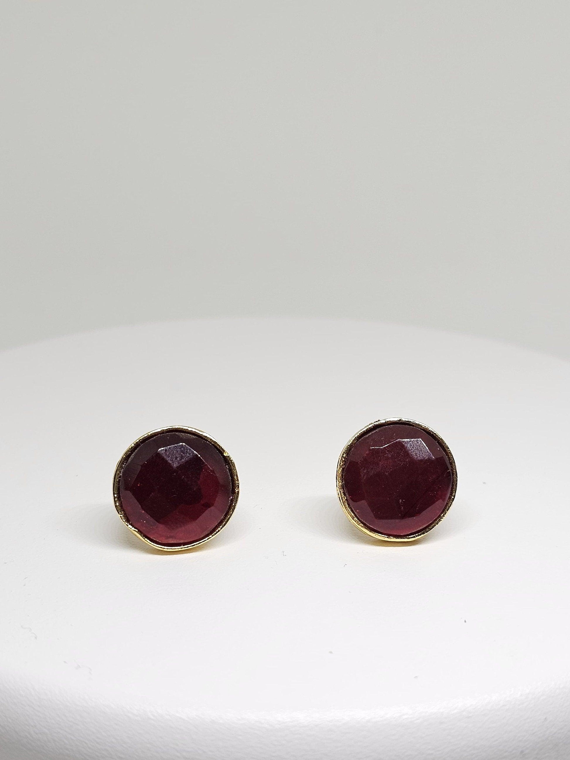 Handcrafted brass stud earrings featuring deep red gemstone, perfect for a sophisticated and elegant look