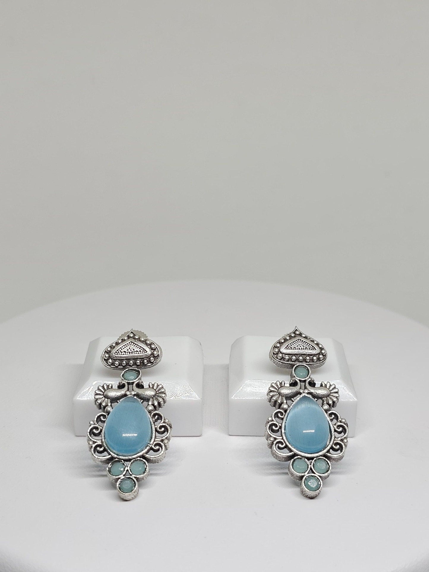 Handcrafted boho earrings with pale blue stones and vintage silver design.