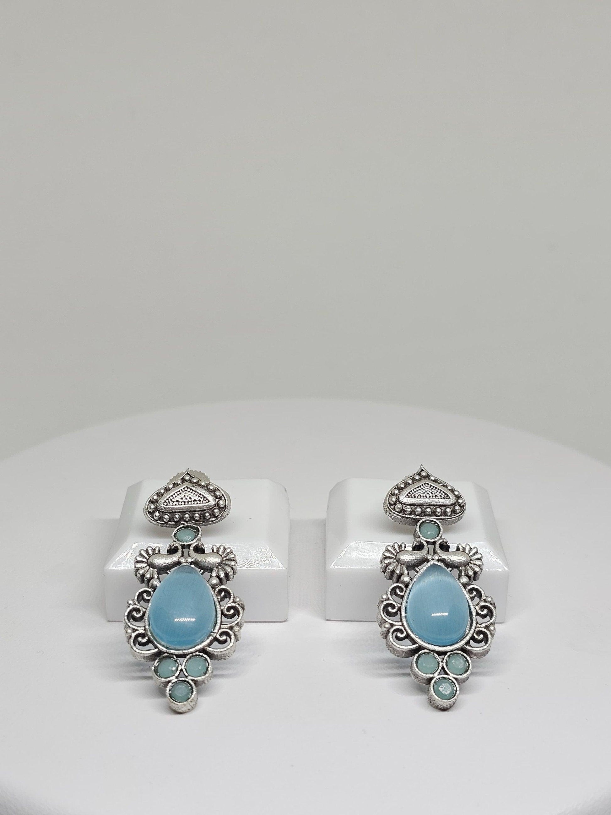 Handcrafted boho earrings with pale blue stones and vintage silver design.