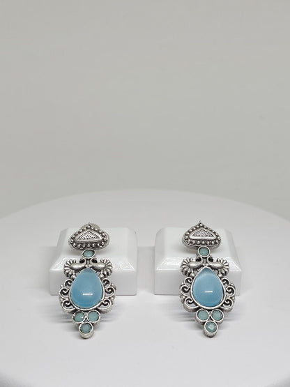 Handcrafted boho earrings with pale blue stones and vintage silver design.