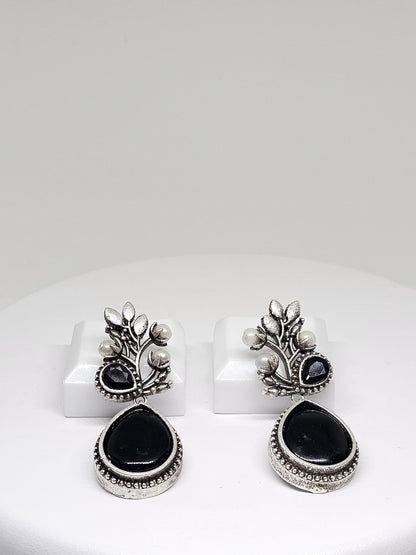 Elegant silver oxidized earrings featuring black stone and pearl details, perfect for ethnic wear