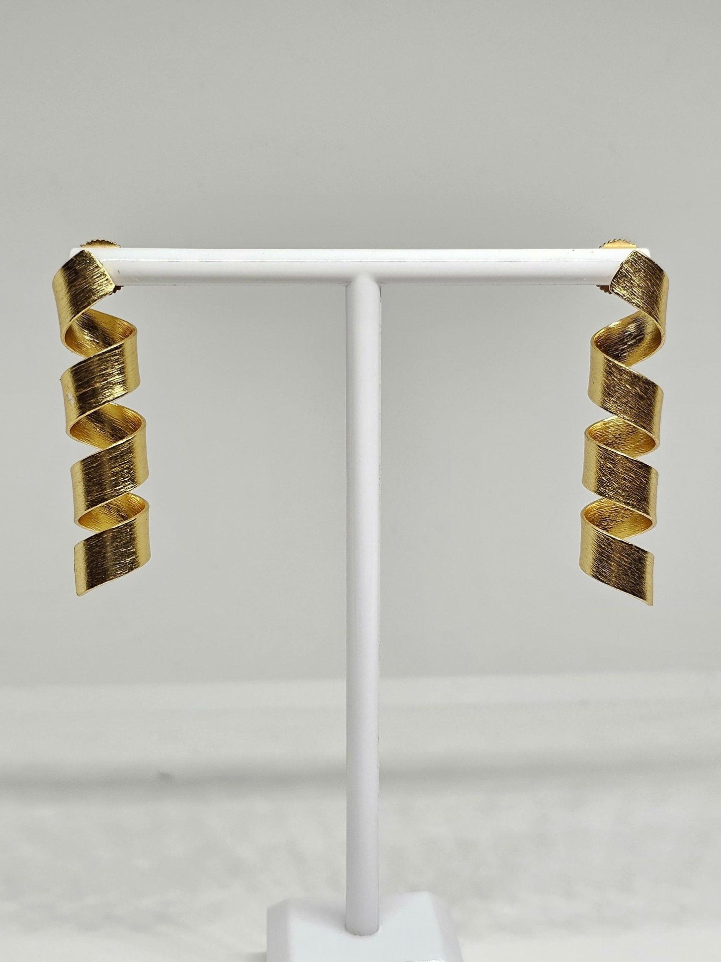 Trendy matte finish spiral drop earrings in gold tone, ideal for parties and elegant occasions