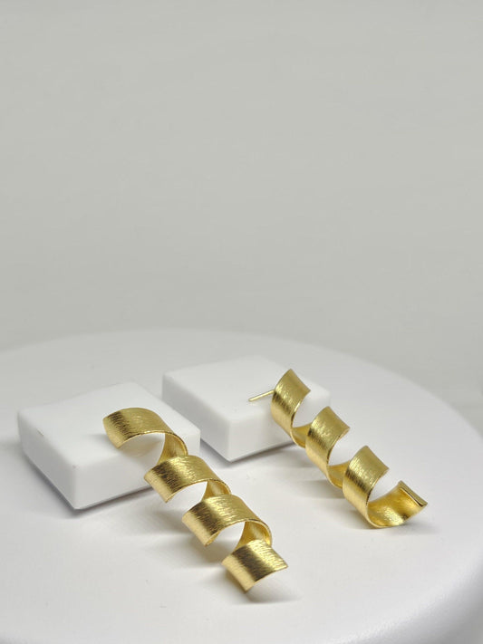 Modern gold-toned spiral drop earrings with a matte finish, featuring a stylish helix design.