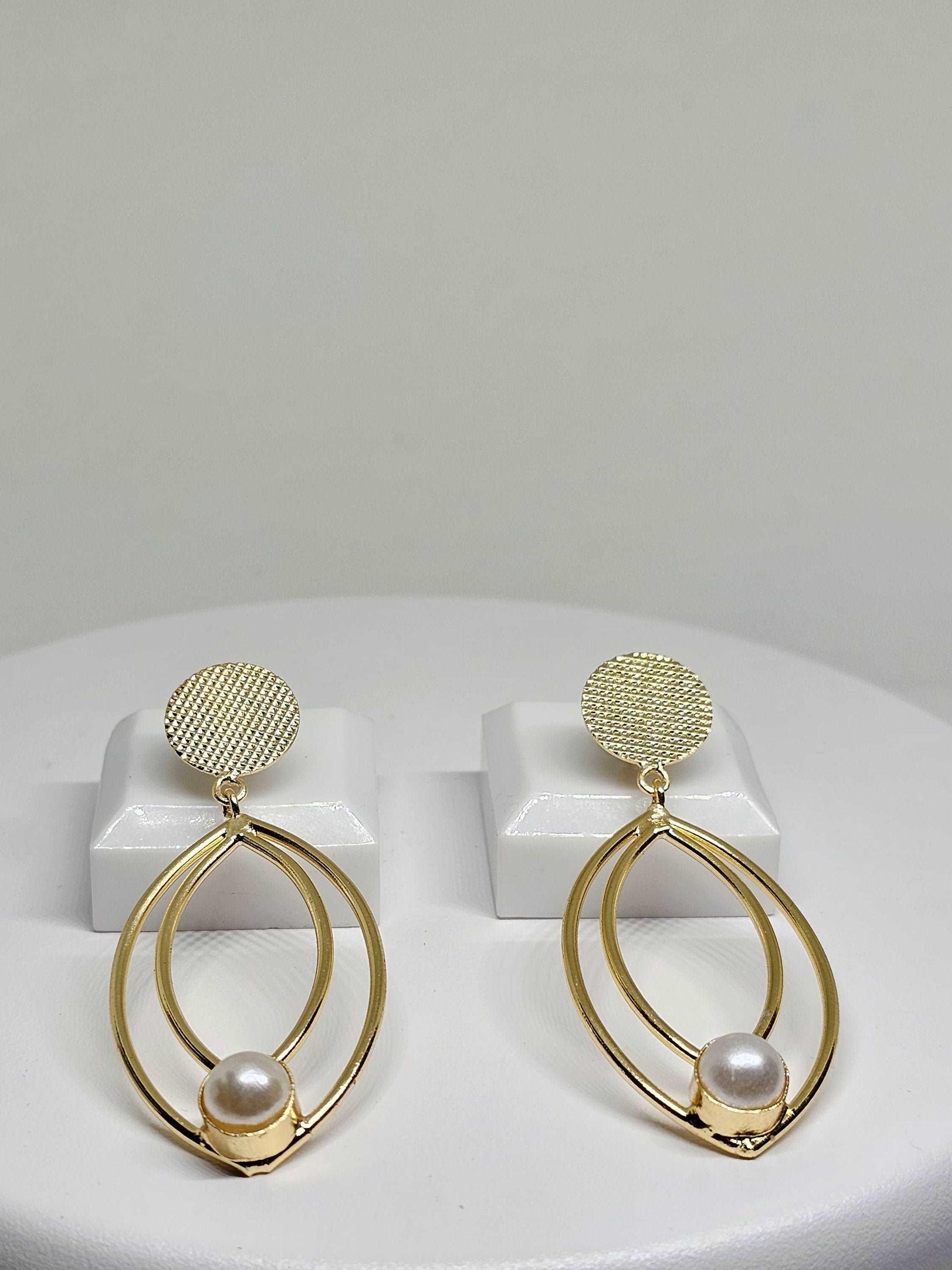 Elegant gold earrings featuring two teardrop-shaped frames and a pearl accent, perfect for adding a touch of sophistication to any outfit