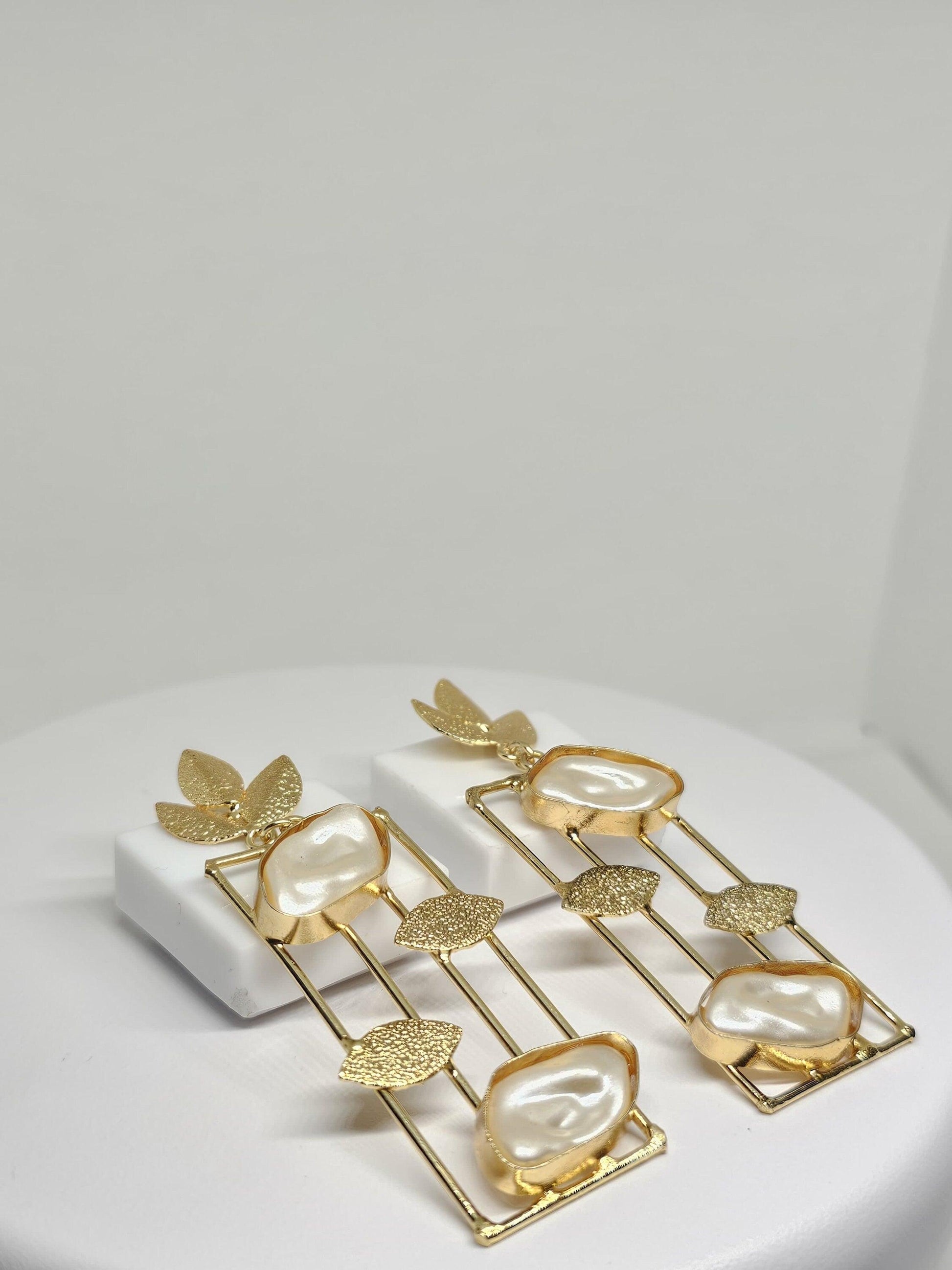 Elegant gold-plated earrings with mother of pearl stones and leaf detailing, perfect for sophisticated style