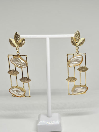 Gold-plated drop earrings with mother of pearl stones, geometric frame, and leaf accents