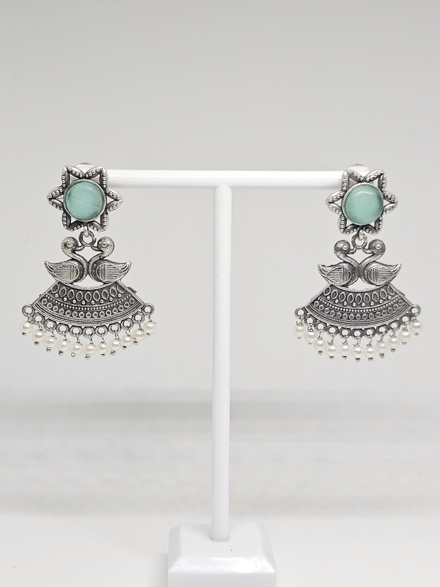 Handmade ethnic earrings featuring duck motifs, star design, and pearl details in oxidized silver