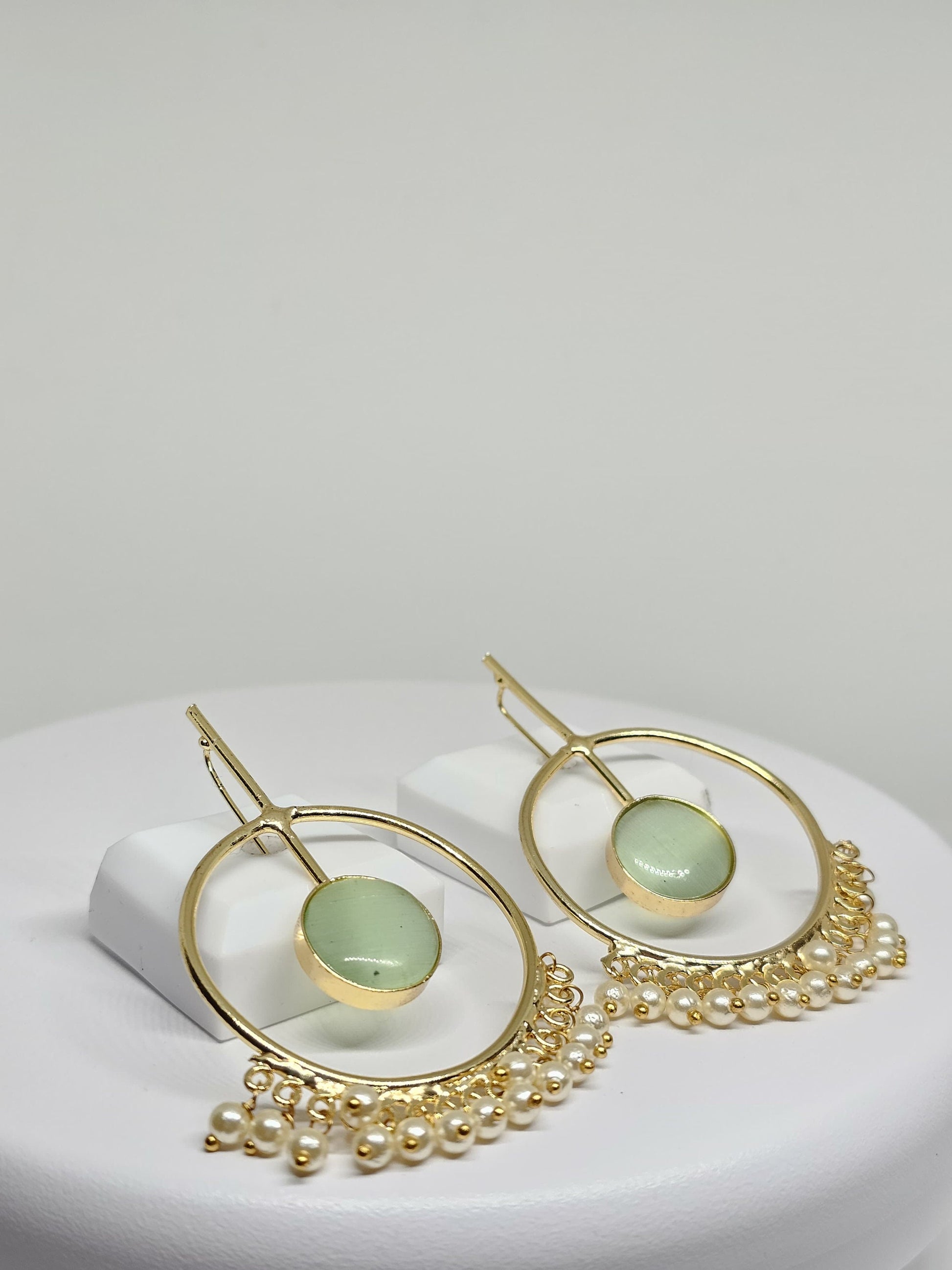 Handcrafted boho-style gold hoop earrings with green gemstone and pearl accents