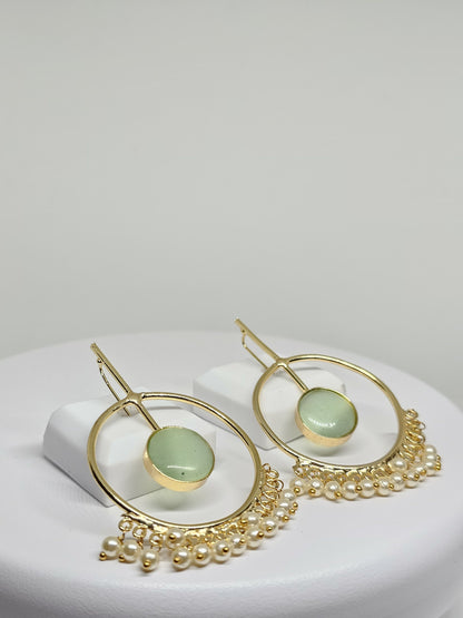Handcrafted boho-style gold hoop earrings with green gemstone and pearl accents