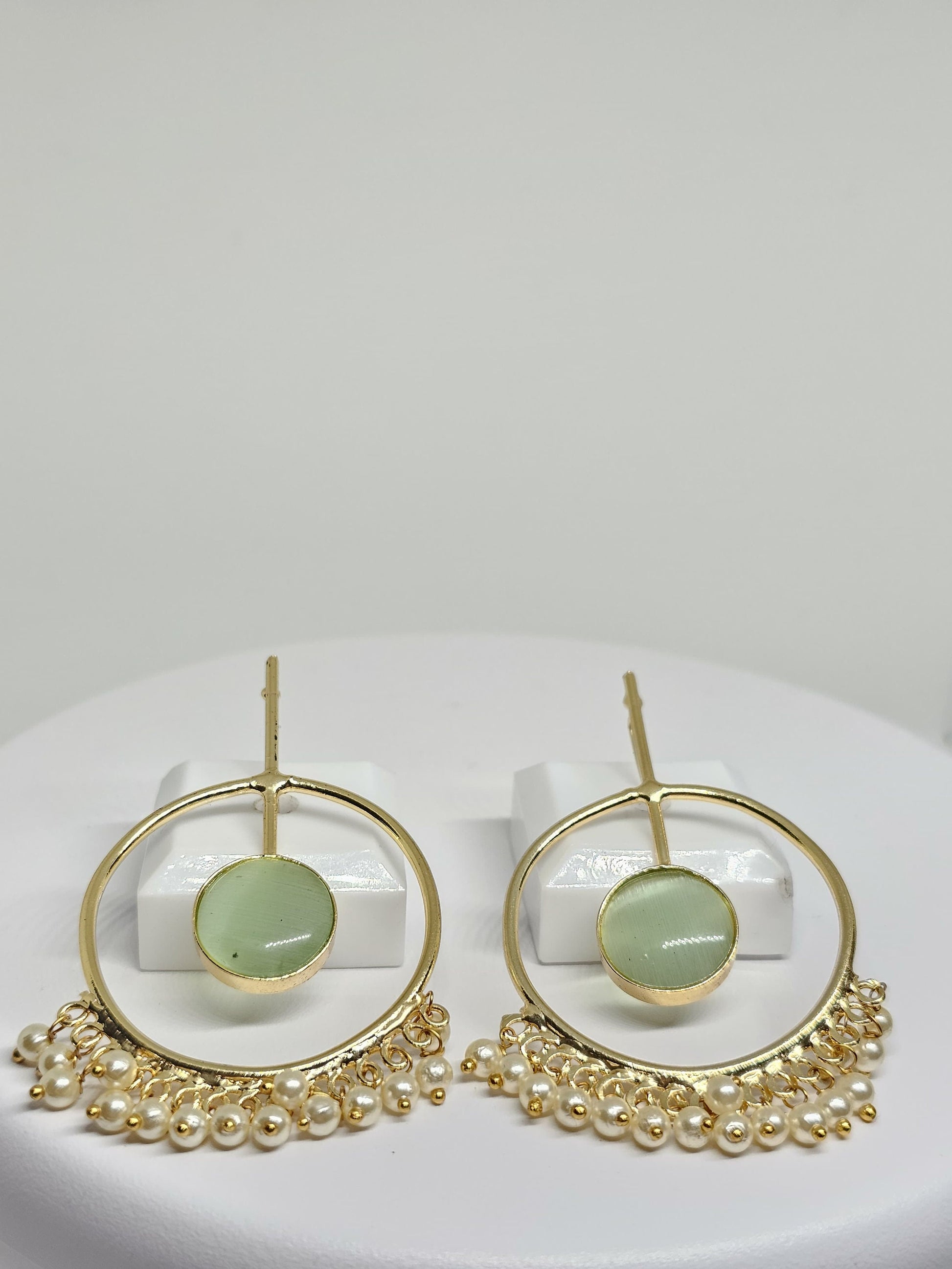 Elegant gold-plated hoop earrings featuring green stone and hanging pearl dangles