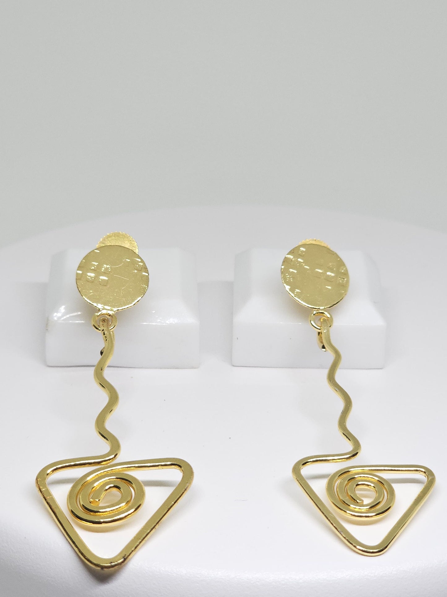 Geometric brass statement earrings with spiral triangle and wavy bar accents