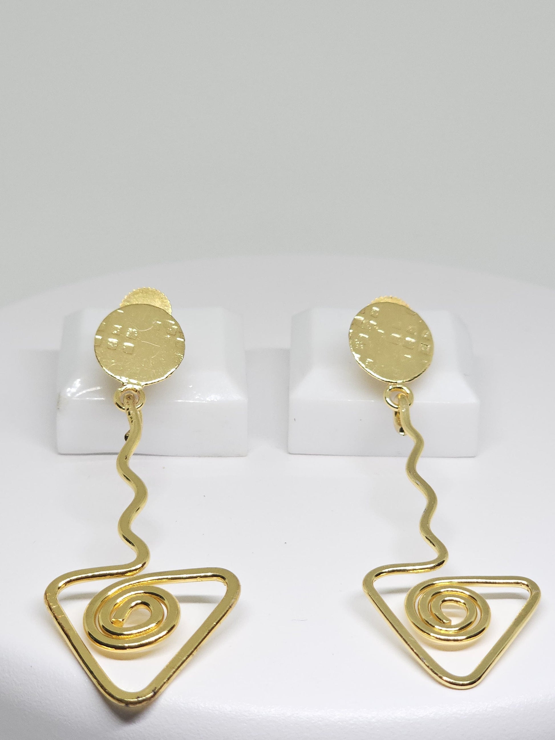 Geometric brass statement earrings with spiral triangle and wavy bar accents