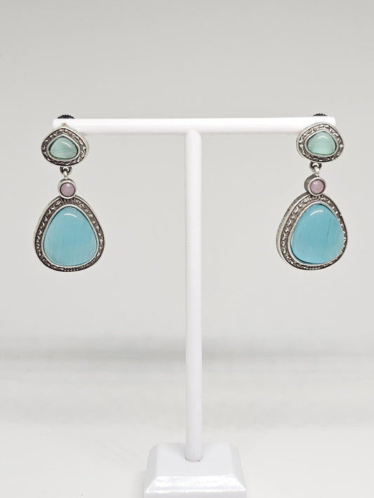 Handmade teardrop earrings featuring aqua blue and light green stones in oxidized silver