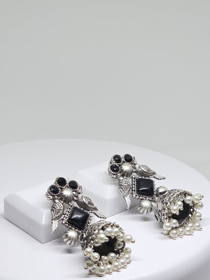 Artisan silver earrings with bird motif, black stones, and pearls