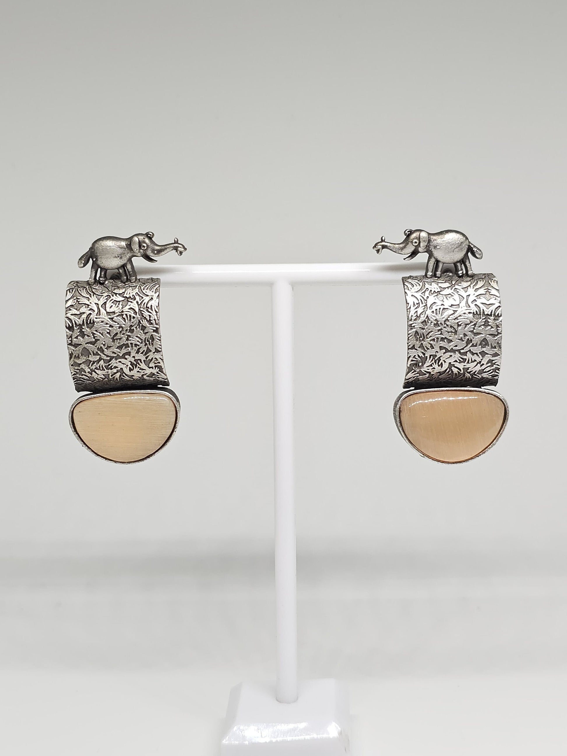 Close-up of brown stone variation of handcrafted elephant motif earrings