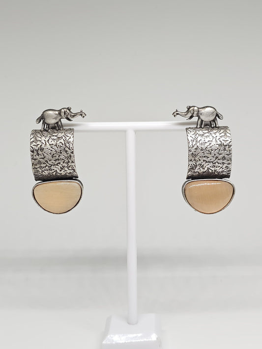 Close-up of brown stone variation of handcrafted elephant motif earrings