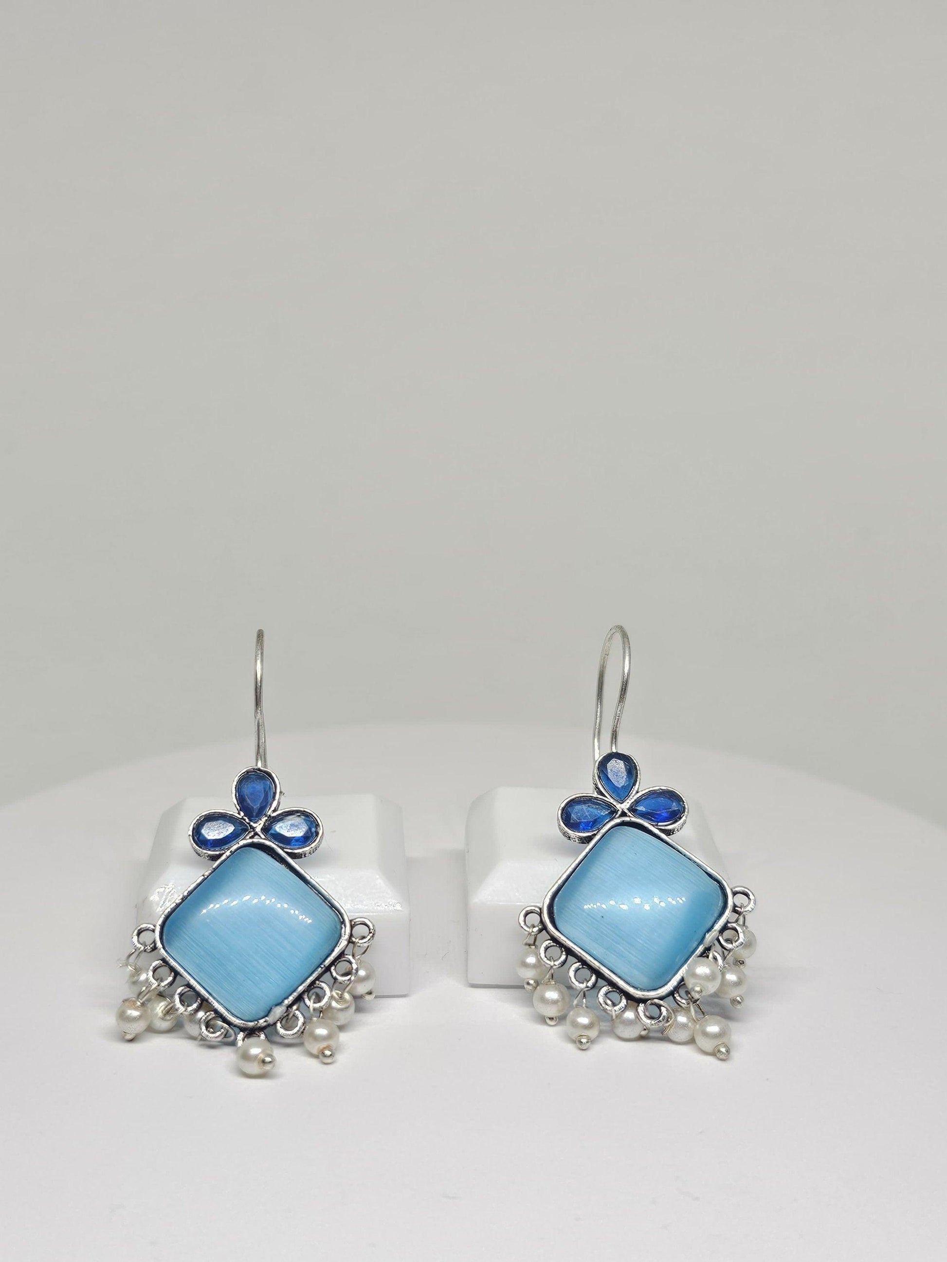 Blue gemstone and pearl silver dangle earrings.