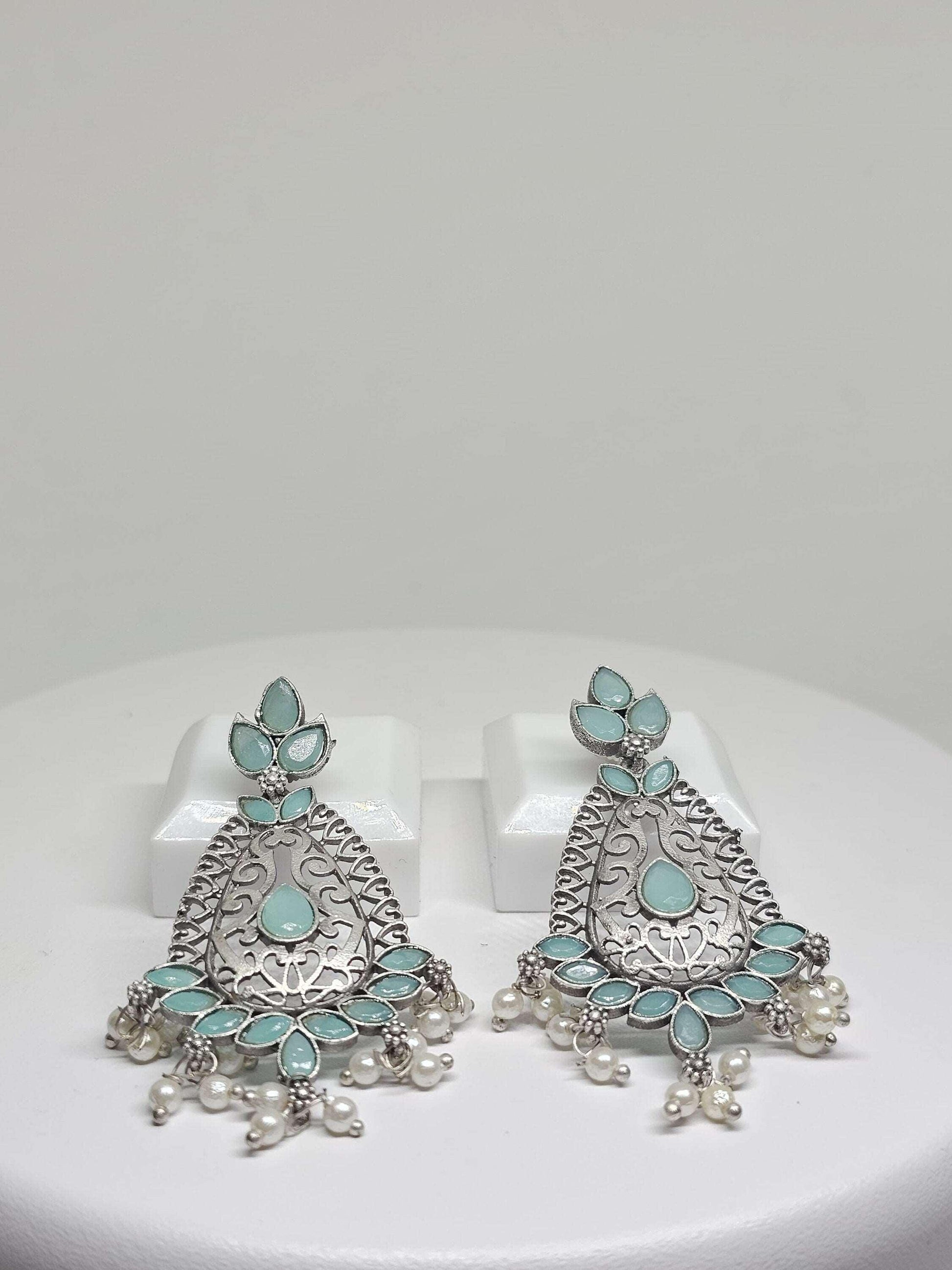 Traditional and modern blended earrings with turquoise stones and pearl details