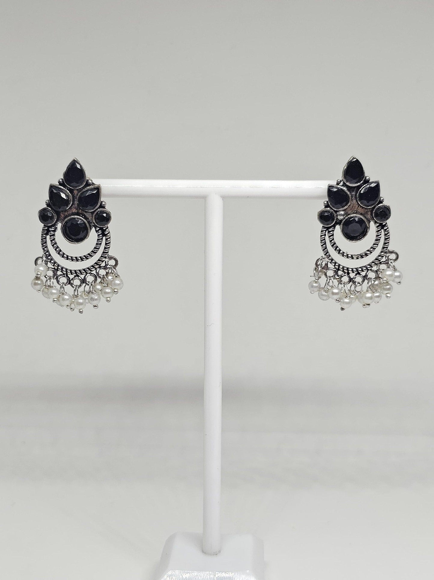 Vintage-inspired tribal earrings with black onyx stones, pearls, and silver detailing