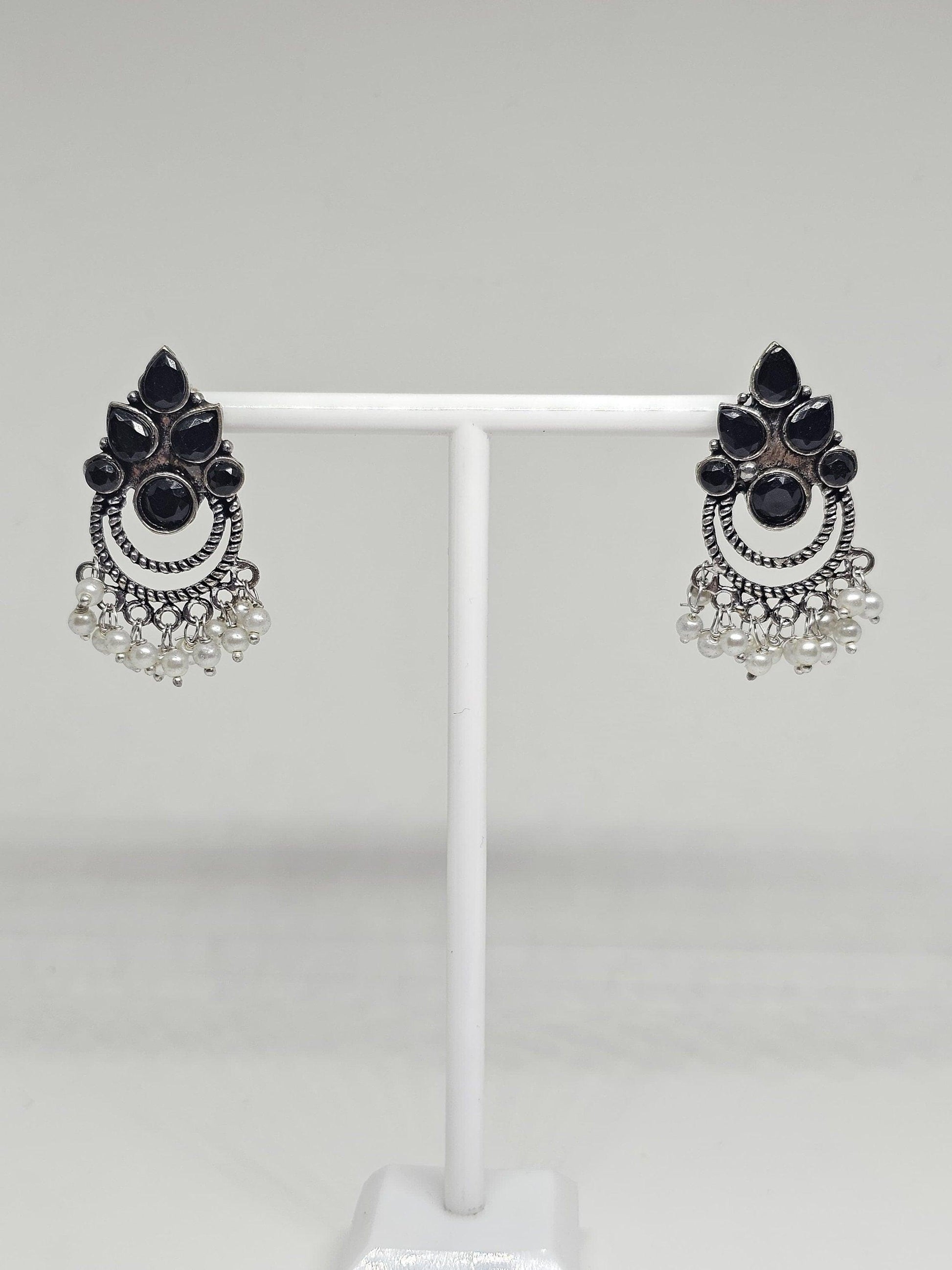 Vintage-inspired tribal earrings with black onyx stones, pearls, and silver detailing