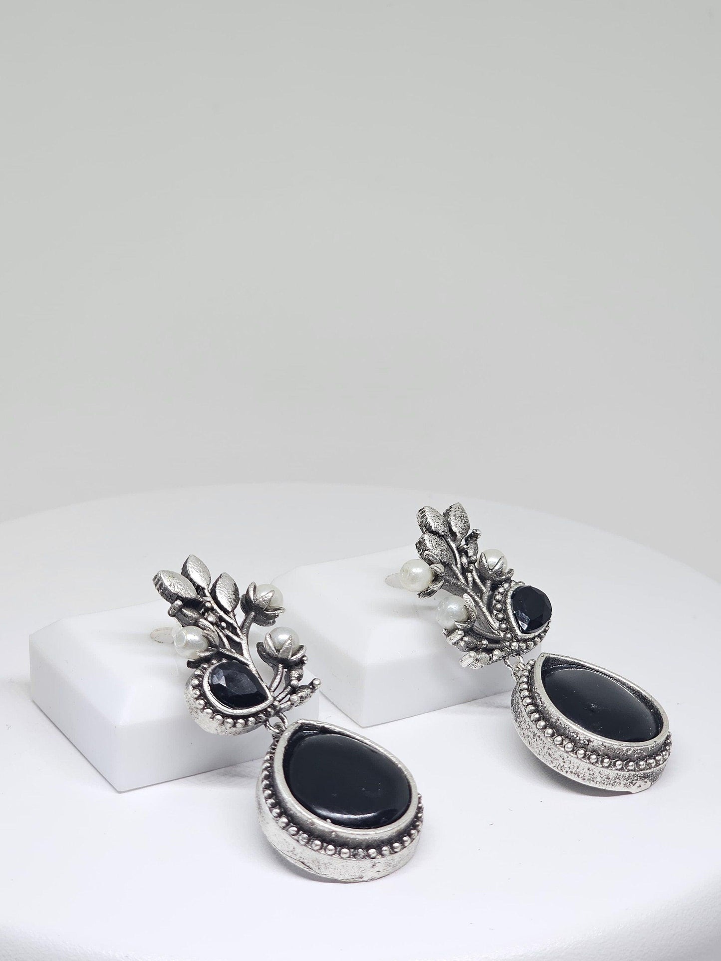 Handcrafted silver drop earrings with a black stone design, adorned with pearls, for women’s traditional fashion