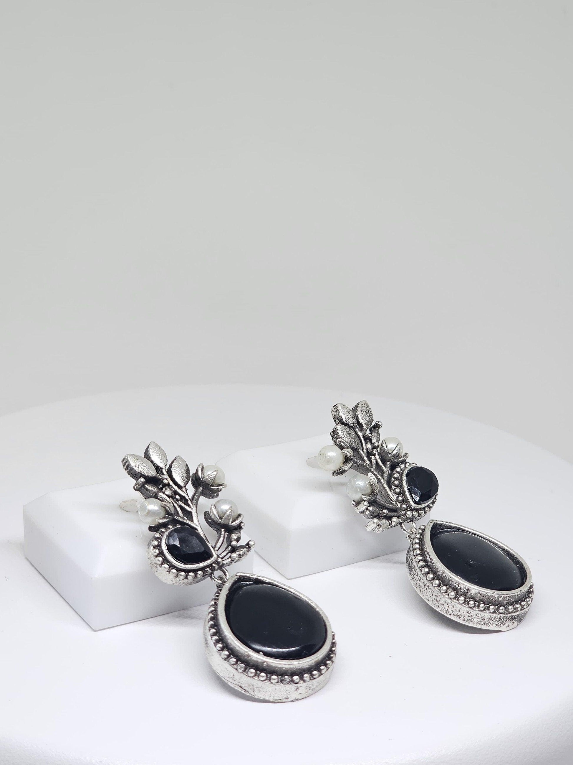 Handcrafted silver drop earrings with a black stone design, adorned with pearls, for women’s traditional fashion