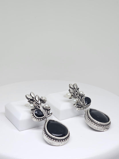 Handcrafted silver drop earrings with a black stone design, adorned with pearls, for women’s traditional fashion