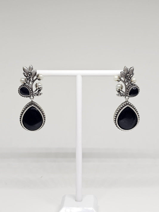 Silver oxidized drop earrings with black stone centerpiece and pearl accents, traditional handmade jewelry