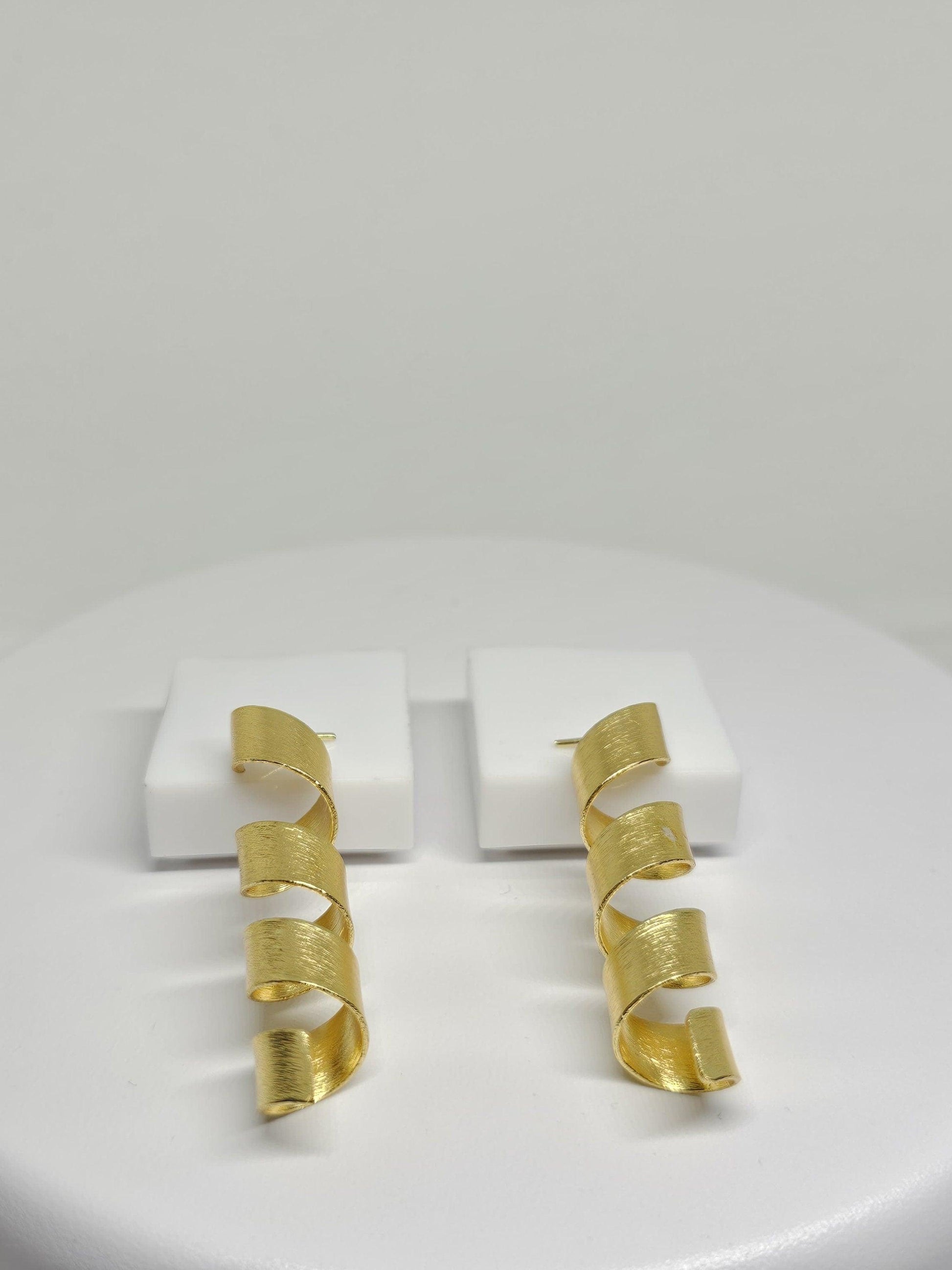 Gold-toned helix design earrings with a minimalist aesthetic, perfect for fashion-forward women