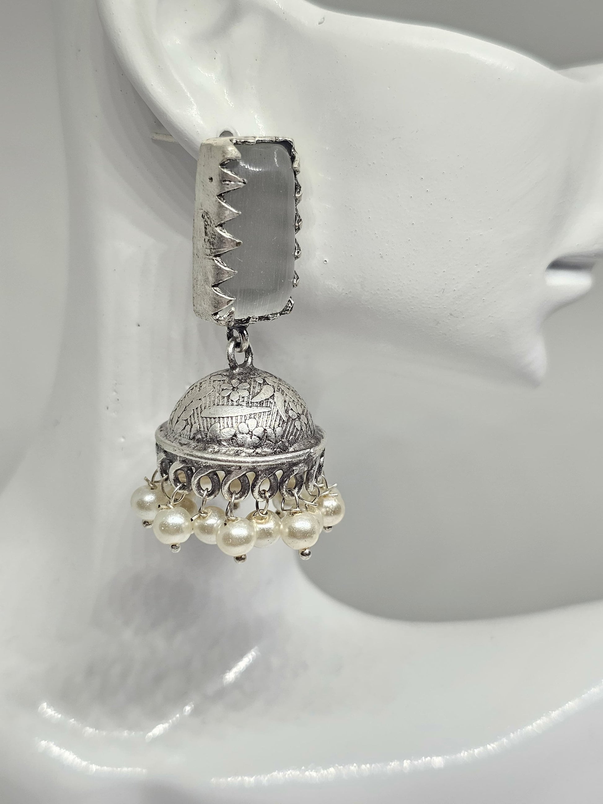 Ethnic silver jhumka earrings featuring grey gemstones and delicate pearl dangles