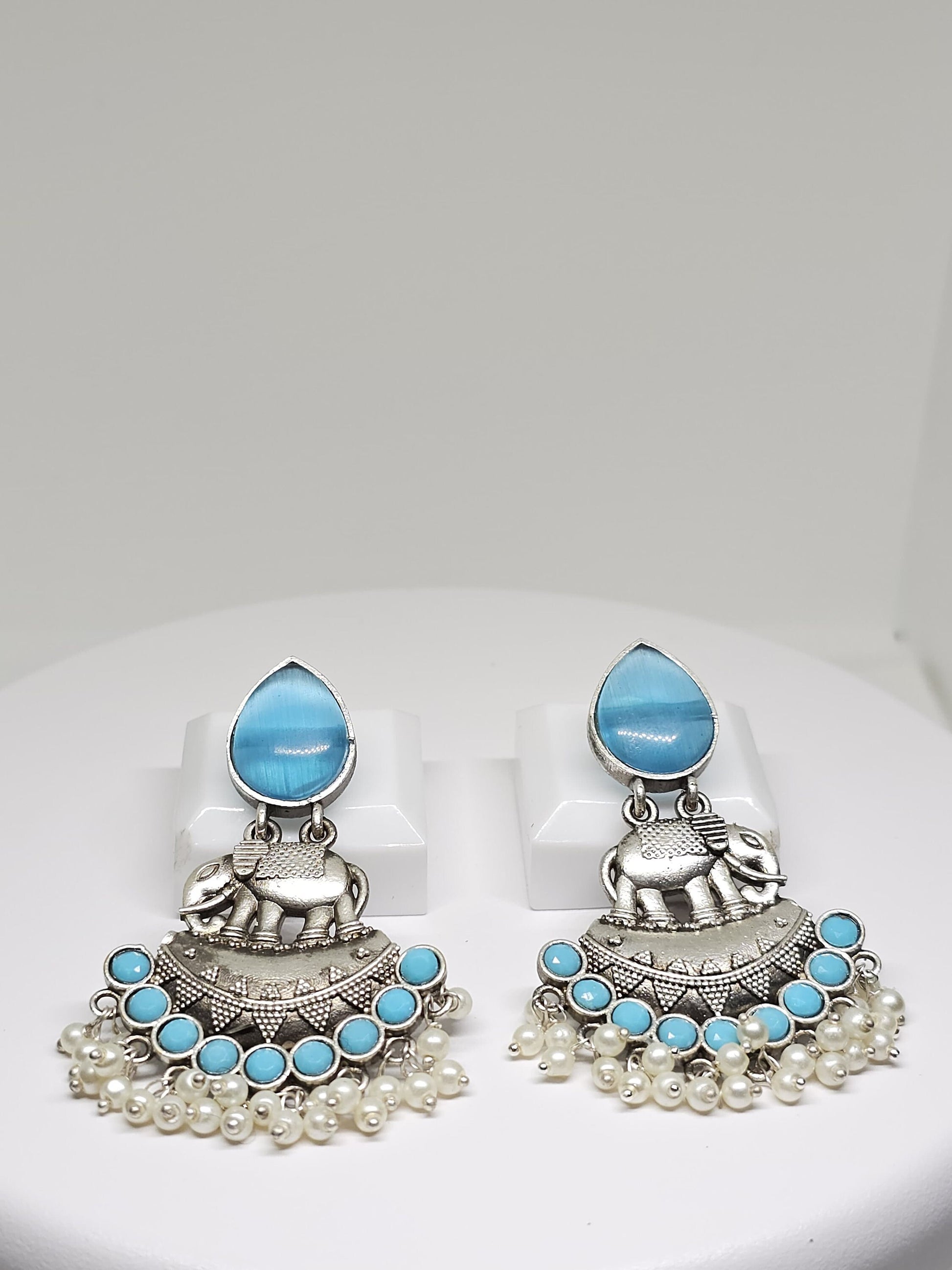 Silver elephant earrings with blue gemstones and pearl dangles, ethnic-inspired fashion accessory