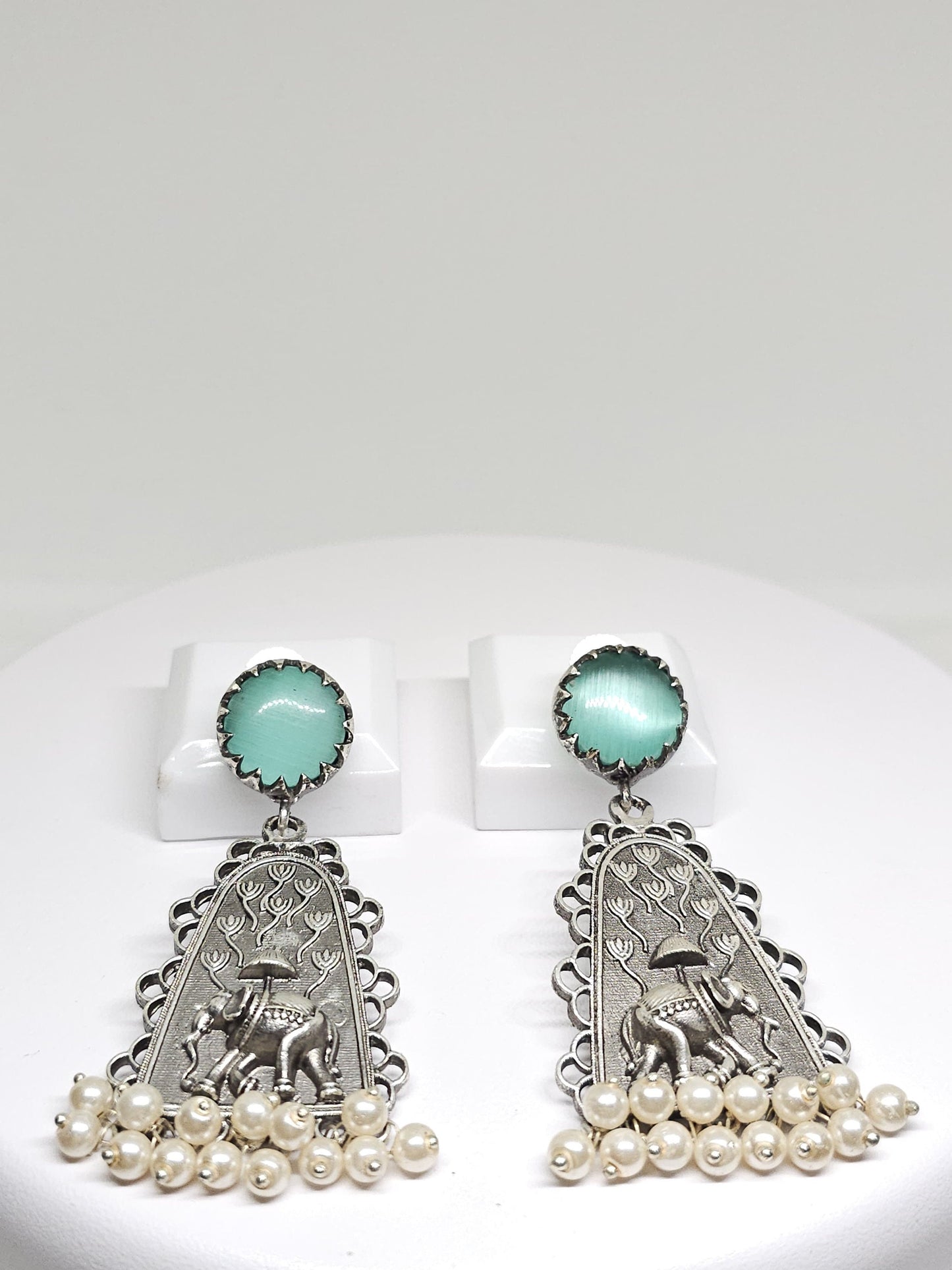 Silver earrings featuring mint green gemstones and elephant design, with pearl drops, unique bohemian jewelry